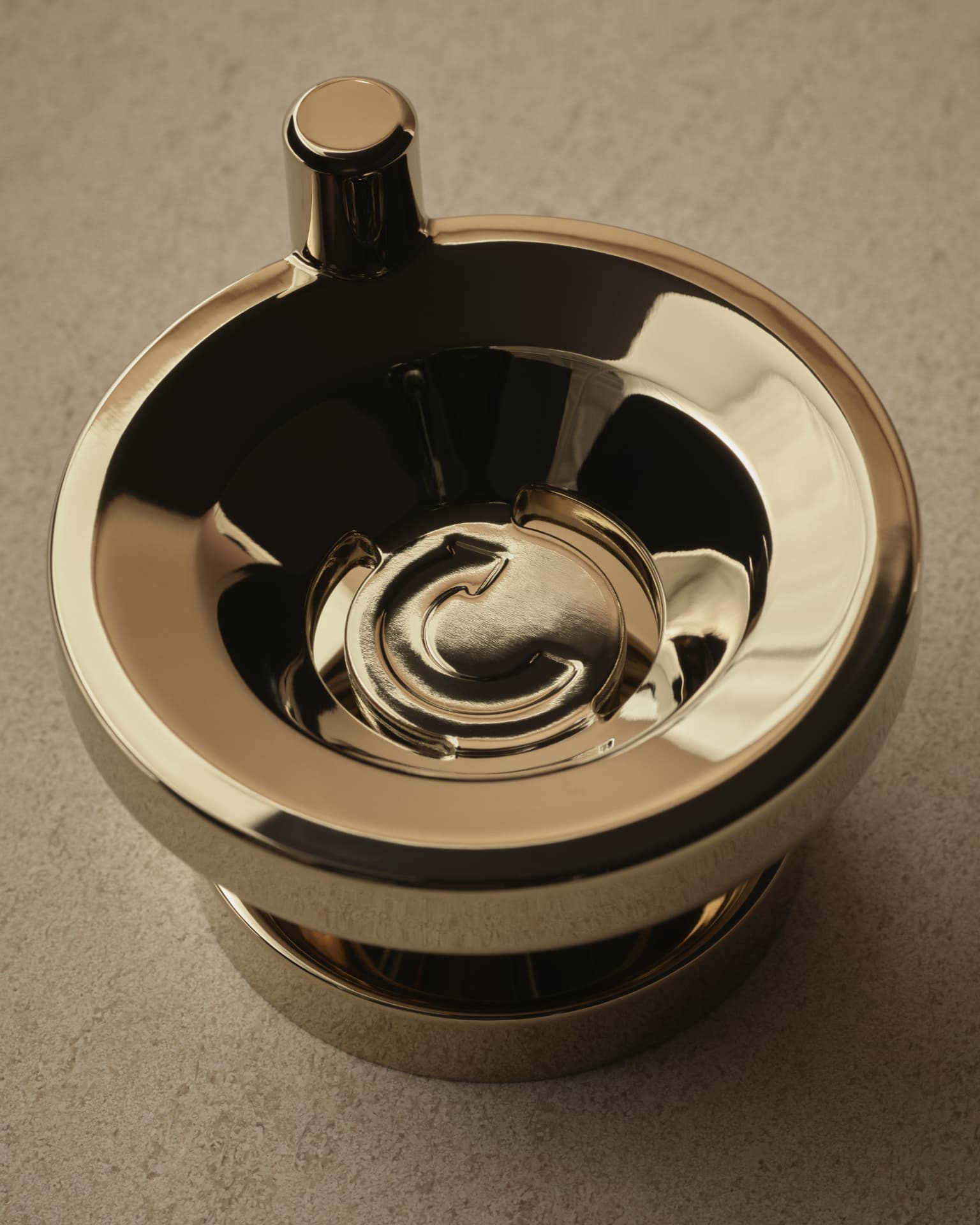 Polished Kallista control detail photographed on warm stone