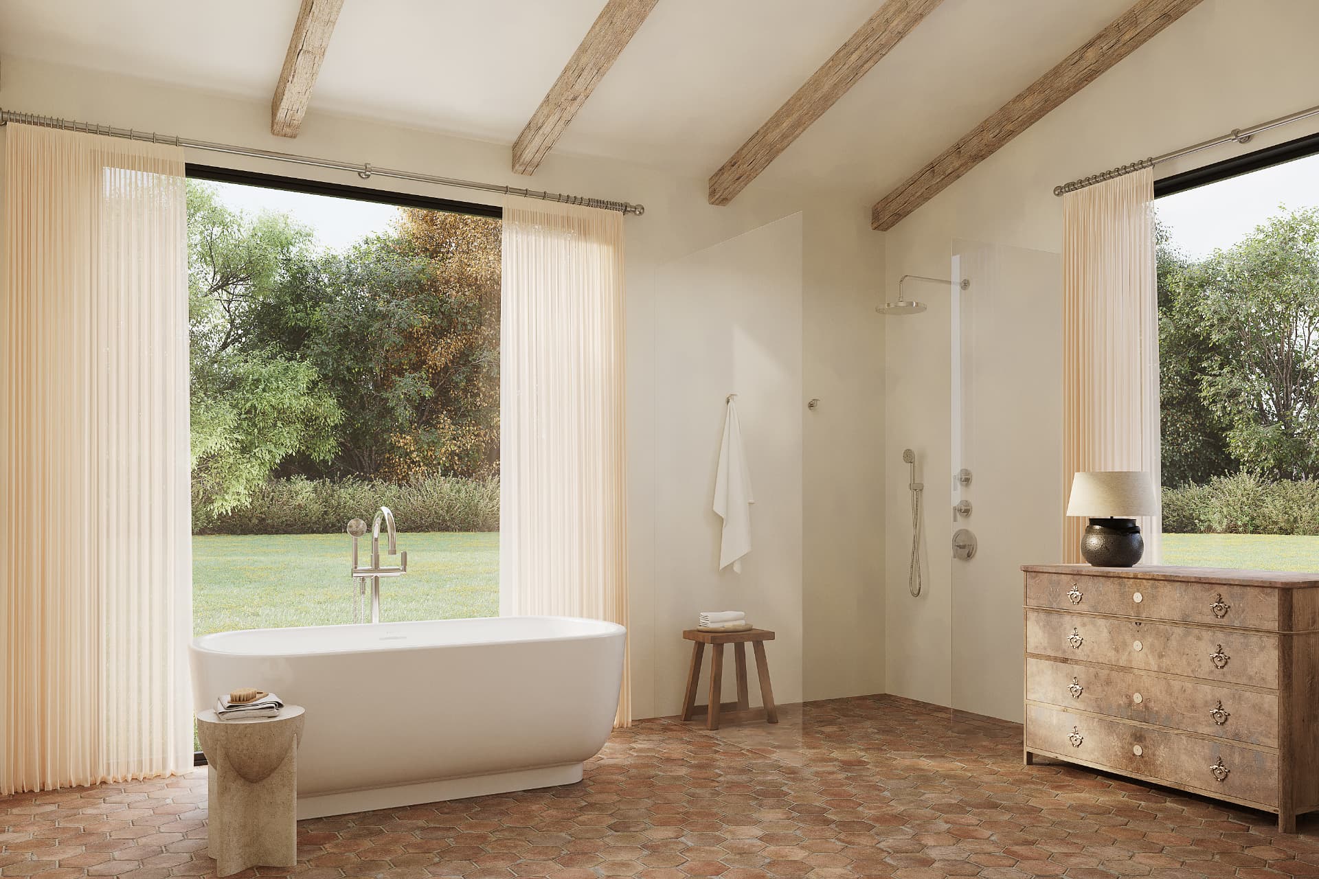 Freestanding tub in a light-filled bathroom with garden views and exposed beams