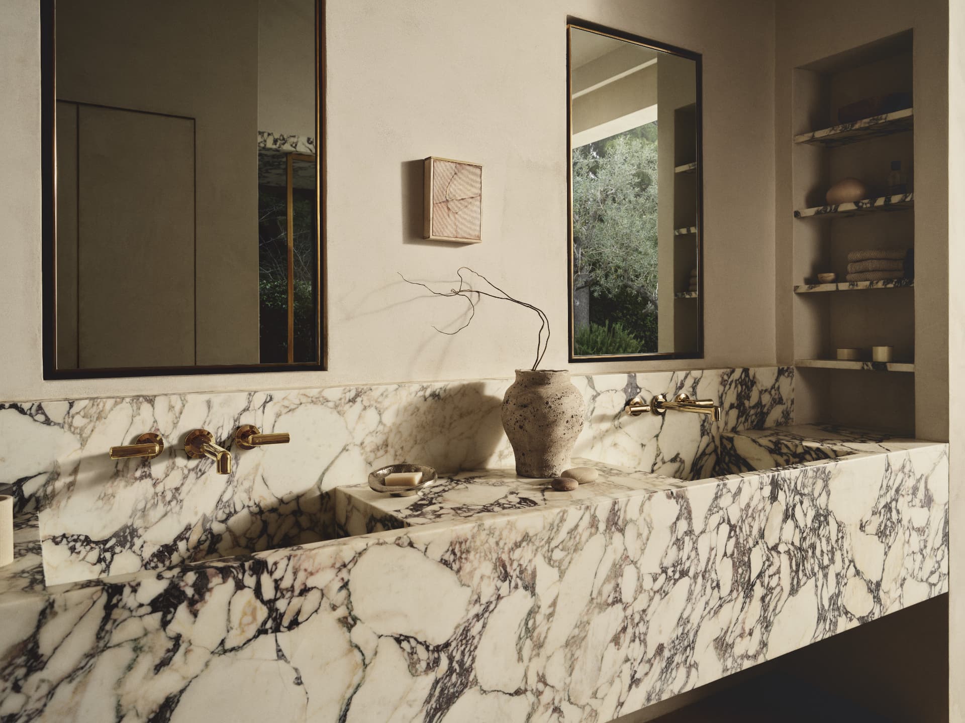 Expansive Kallista bathroom vanity crafted in richly veined marble