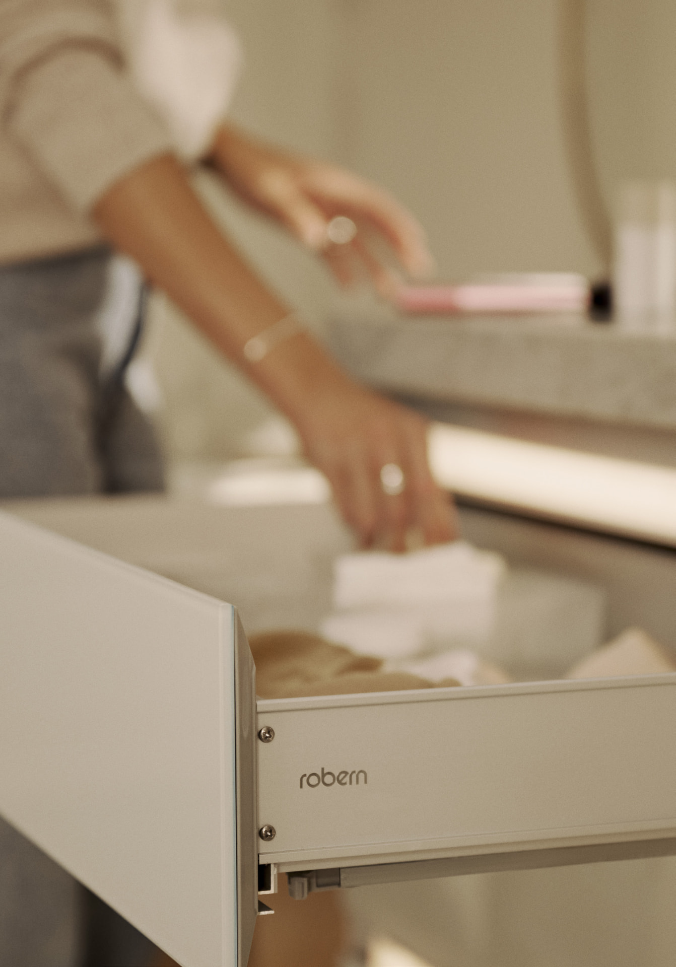 Hand reaching into an open Robern vanity drawer