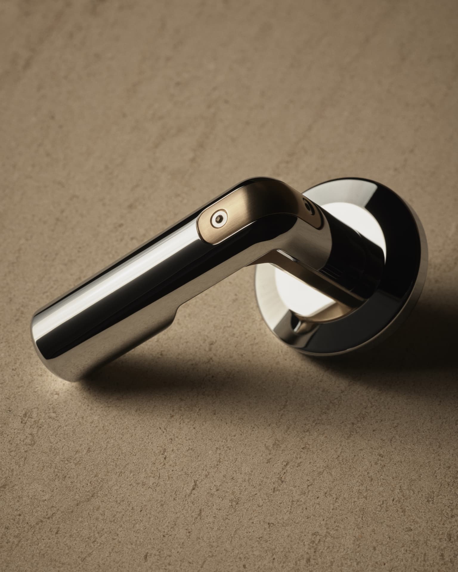 Polished Kallista handle detail resting on warm textured stone