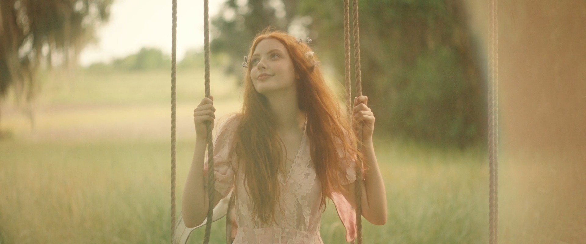 Film still from This World of Magic: a figure staged in a constructed garden tableau
