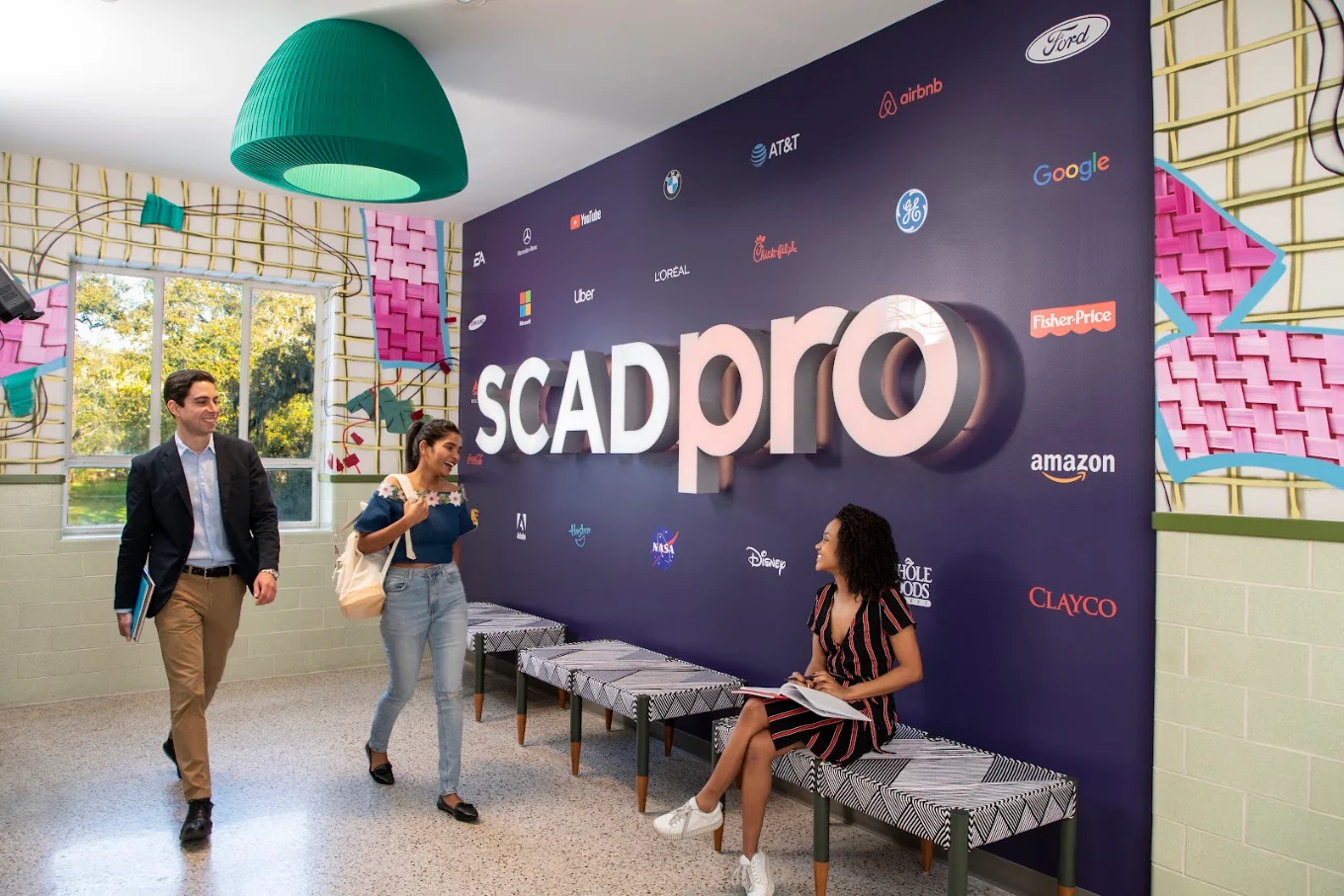 SCADpro branded partnership studio with students and corporate sponsor logos