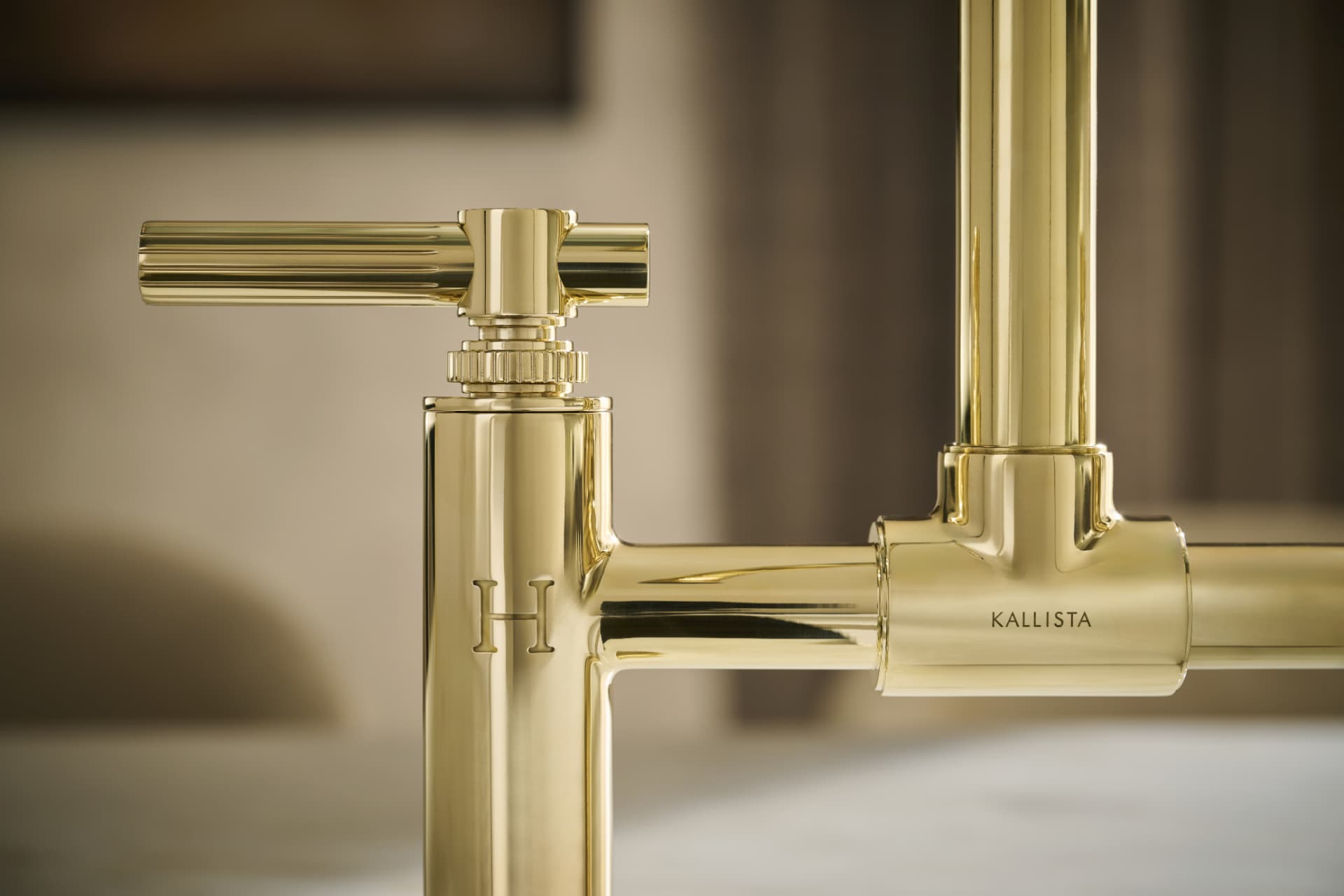 Close detail of a polished brass Kallista faucet handle